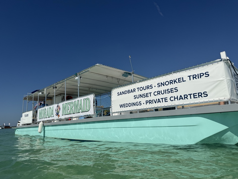 A clean broadside of the Morada Mermaid catamaran with its full services banner readable