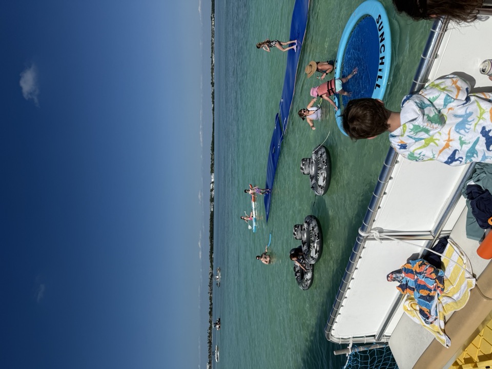 The view from the boat deck looking down on floating mats and tubes at the sandbar