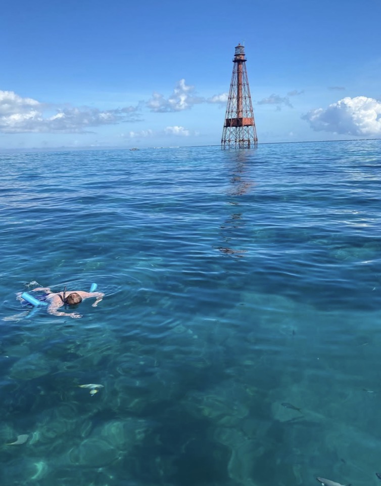 A snorkeler gliding over the coral heads in clear Islamorada water