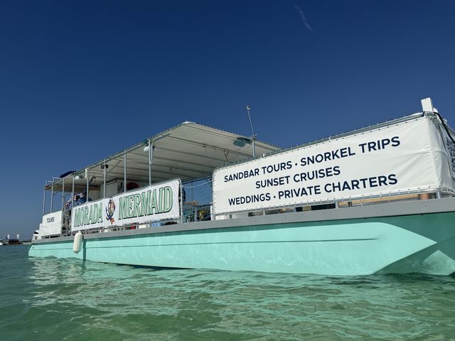 A clean broadside of the Morada Mermaid catamaran with its full services banner readable