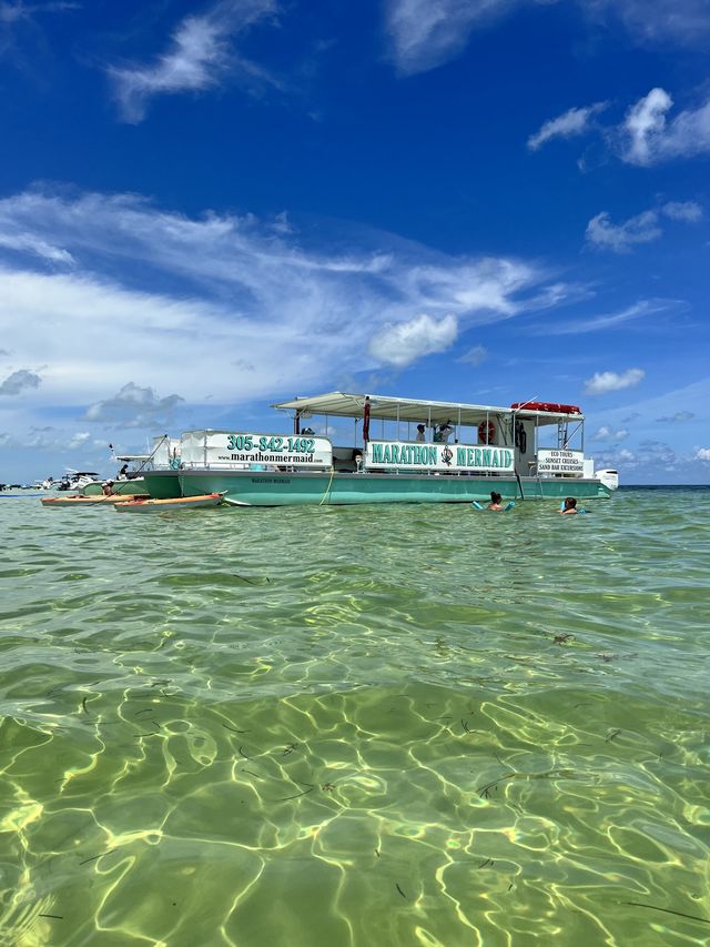 The Marathon Mermaid catamaran anchored over crystal-clear shallow water