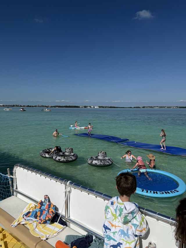 The view from the boat deck looking down on floating mats and tubes at the sandbar