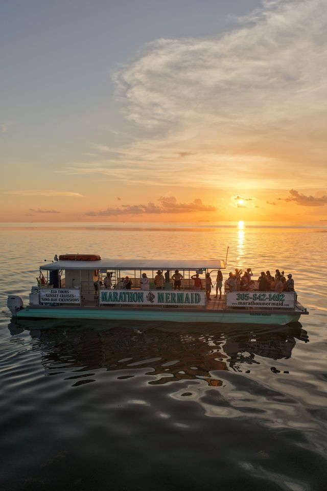 The Marathon Mermaid catamaran glowing against a golden Keys sunset