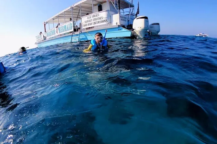 a person standing next to a body of water