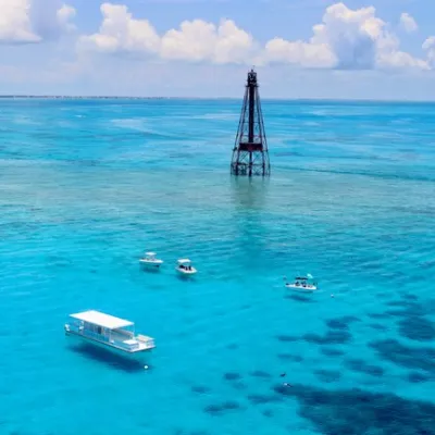 a blue and white boat sitting next to a body of water