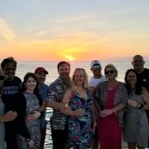 a group of people standing next to a body of water