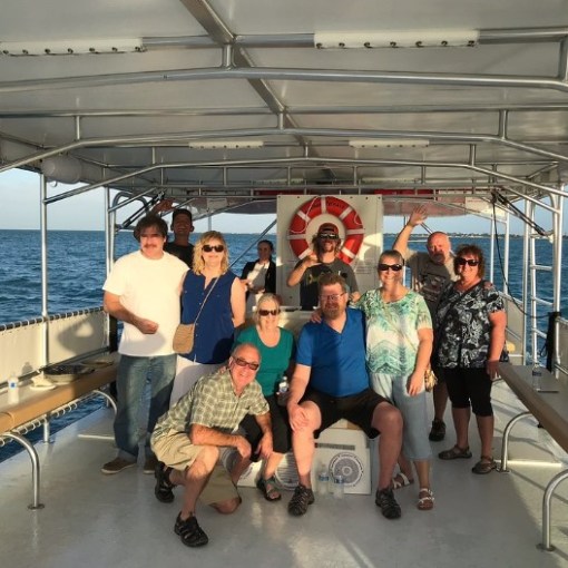 a group of people standing on a boat