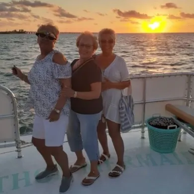 a group of people standing on a beach