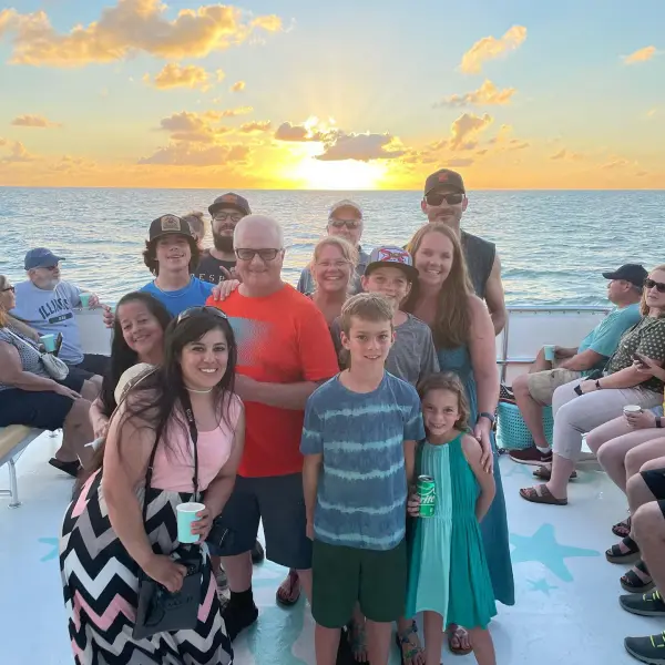 a group of people standing in front of a crowd posing for the camera